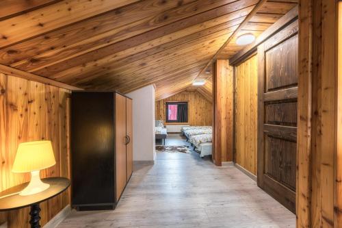 a hallway of a house with wooden walls and a lamp at Anna Sela in Vrbov