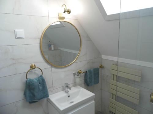 a bathroom with a sink and a mirror at Millennium Villa in Keszthely