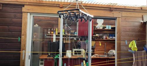 a house with a window and a kitchen with a chandelier at Loc 'FCathy in Saint-Benoît