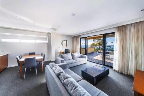 a living room with a couch and a table at Bayside Geelong Hotel & Apartments, an Ascend Collection Hotel in Geelong