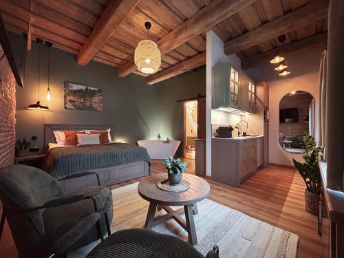 a bedroom with a bed and a table in a room at Apartment No 14 in Līgatne