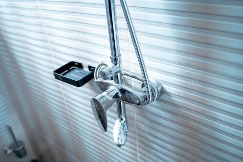 a shower head in a bathroom next to a window at Ligas homes in Dodoma