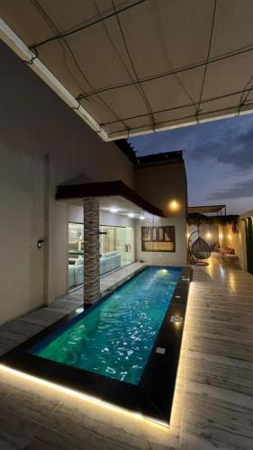 a swimming pool in the middle of a building at استراحه بيت الزلفى in Fulūj Sayghah