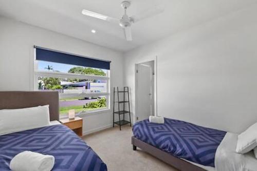 a bedroom with a bed and a window at Palm Haven Coolum Beach in Coolum Beach