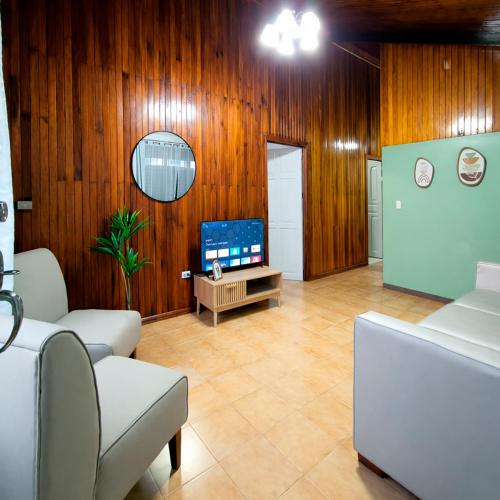 a living room with a couch and a tv at La Casa del Centro in Quesada