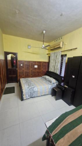 a bedroom with a bed and a desk at Yara Homes in Cochin