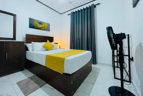 a bedroom with a bed with a tv on a tripod at Villa One Hikkaduwa in Hikkaduwa
