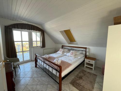 a bedroom with a bed in a attic at Herczeg Villa in Balatongyörök