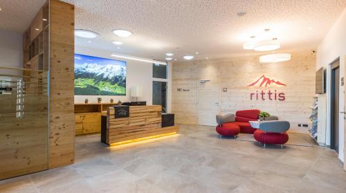 a salon with red chairs and a waiting room at Rittis Alpin Chalets Dachstein in Ramsau am Dachstein