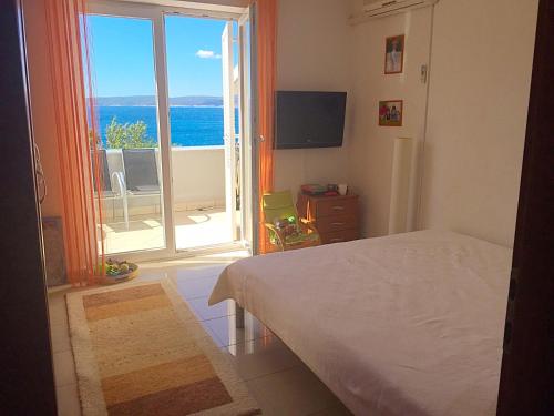 a bedroom with a bed and a view of the ocean at Apartment Svetlana in Selce