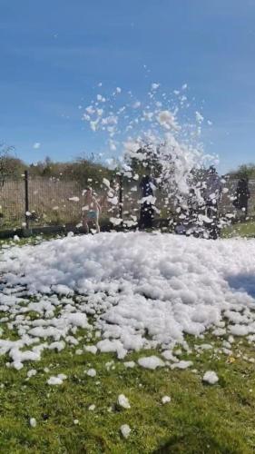 a pile of snow on the ground in a field at Domki Letniskowe BŁĘKIT in Gąski