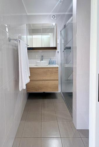 a bathroom with a sink and a shower at Rainbow House in Rainbow Beach