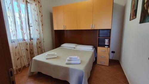 a bedroom with a bed with two towels on it at Piccolo Residence Gallipoli in Gallipoli