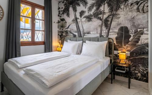 a bedroom with a large bed with a painting on the wall at Monamie-Windsor Park in Adeje