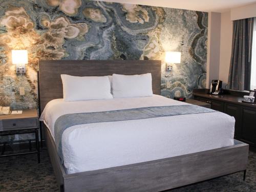 a bedroom with a large bed with a wall at Turf Valley Resort in Turf Valley