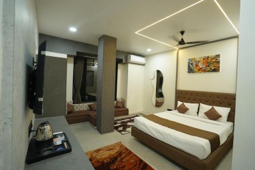 a bedroom with a bed and a living room at Hotel Ace Inn in Dr. Babasaheb Ambedkar International