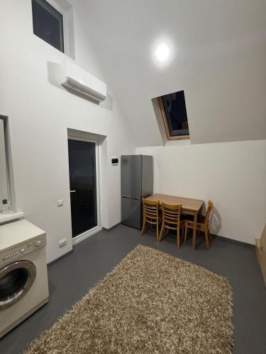 a kitchen with a table and chairs and a refrigerator at Apartament in Chişinău