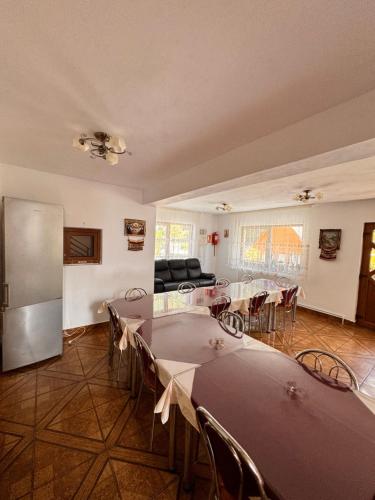 a large room with tables and chairs and a couch at Pensiunea Emanuel in Gârda de Sus