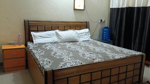 a bed in a bedroom with at Shubharohi stay in Chhatikara