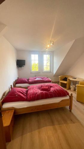 a bedroom with two beds in a attic at Gästehaus Wedework in Wedemark