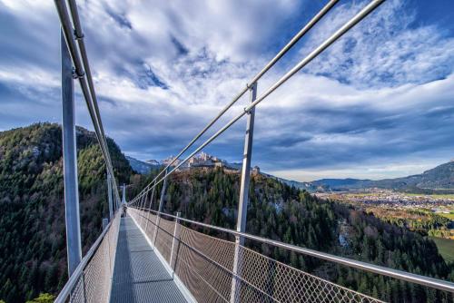 a suspension bridge with a view of a city at Gasthof Salzstadl in Reutte