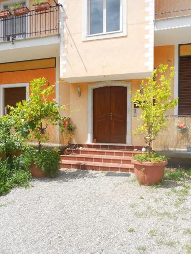 a house with two trees in front of a door at L'Oasi in Auletta