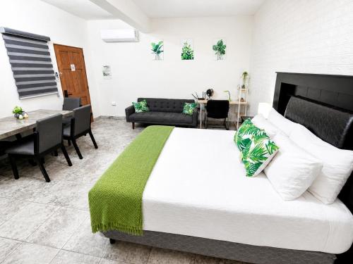 a bedroom with a bed and a dining room at Cabo Downtown Studios in Cabo San Lucas