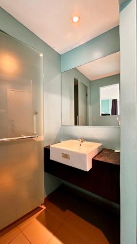 a bathroom with a white sink and a mirror at Bright Hotel in Petaling Jaya