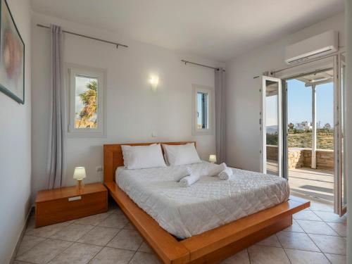 a bedroom with a bed with a teddy bear on it at Angel Serenity Villa in Kampos Paros