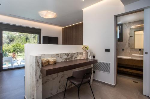a kitchen with a counter and a chair in a room at Casadi Luxury Villa in Ialysos