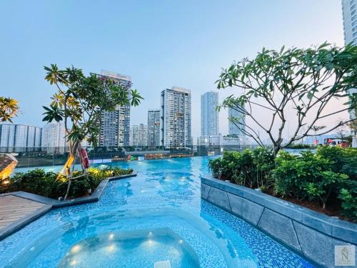 a swimming pool with a city skyline in the background at Lumière Royal Sky Residence in Ho Chi Minh City