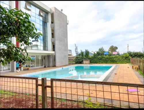 a swimming pool in front of a building at kijani retreat in Nairobi