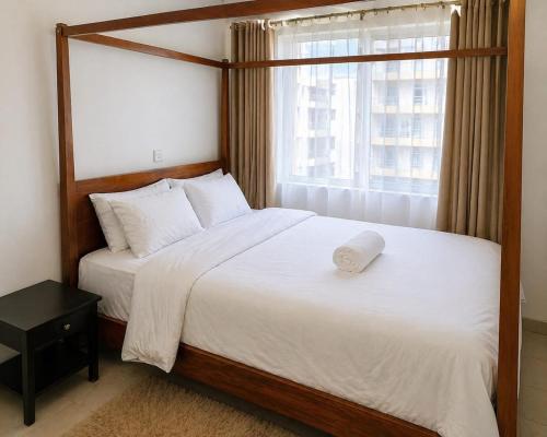a bedroom with a large bed and a window at kijani retreat in Nairobi
