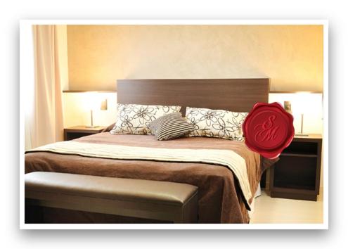 a bedroom with a large bed with a red hat on it at San Martin Plaza Hotel in Villa Elisa
