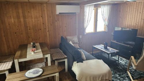 a living room with a couch and a table at Chata Bambi, Tatranská Štrba pri zubačke in Štrba