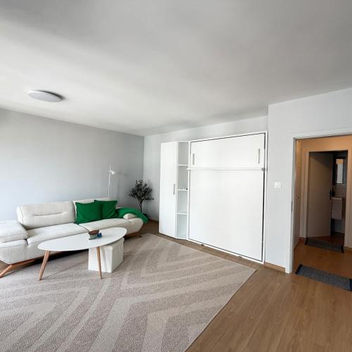 a living room with a couch and a table at Cool Downtown Apartment in Burgas