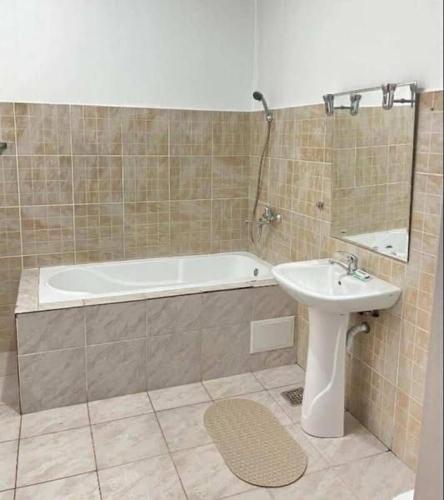 a bathroom with a tub and a sink and a bath tub at LaScena in Techirghiol