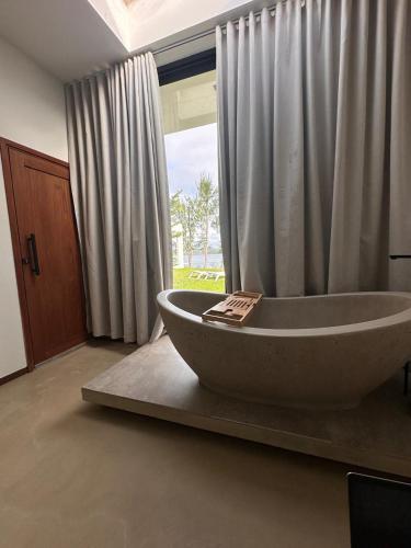 a large bath tub in a bathroom with a window at Dzixile in Gueima