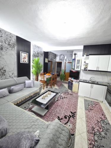 a living room with a couch and a table at Villa Kena in Ksamil