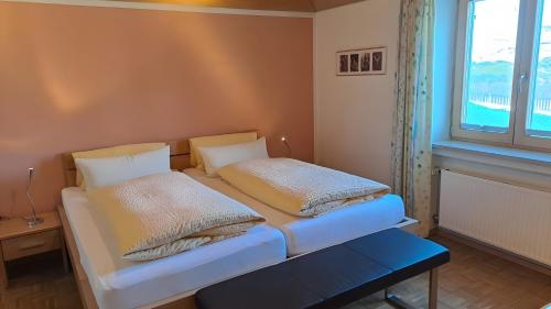 a bedroom with a bed with two pillows on it at Ferienwohnung Hörnle Bad Kohlgrub in Bad Kohlgrub