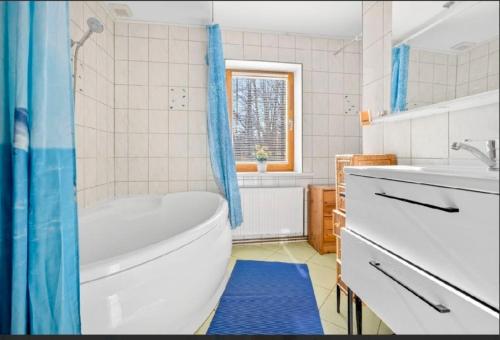a bathroom with a tub and a toilet and a sink at Sweet Home in Koknese