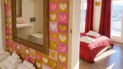 a bedroom with a mirror and a bed in a room at AjoieSpa in Porrentruy