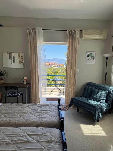 a bedroom with a bed and a window with a view at Bougainvillea Terrace Studio in Sikéa
