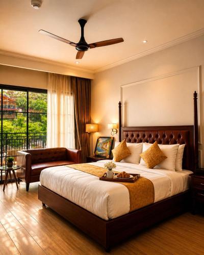 a bedroom with a large bed with a ceiling fan at Tiraya Luxury Riverside Hotel & Café in Gushaini