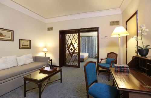 a living room with a couch and a table at Hotel Lisboa Plaza - Lisbon Heritage Collection - Avenida in Lisbon