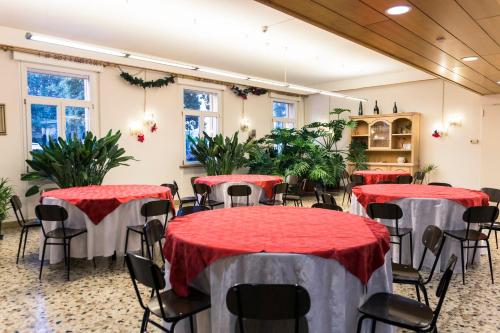 a room with tables and chairs and plants at B&B Centro della Famiglia in Treviso