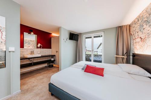 a hotel room with a bed and a sink at Emma's B&B LUNGERN - Self Check-in Hotel in Lungern