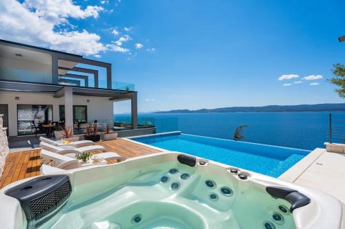 Luxurious beachfront villa Hrid with with Jacuzzi, infinity pool