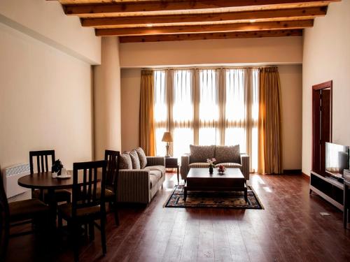 a living room with a couch and a table at CityHotel, Thimphu in Thimphu