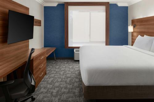 a hotel room with a bed and a television at City Express By Marriott Rancho Cucamonga in Rancho Cucamonga